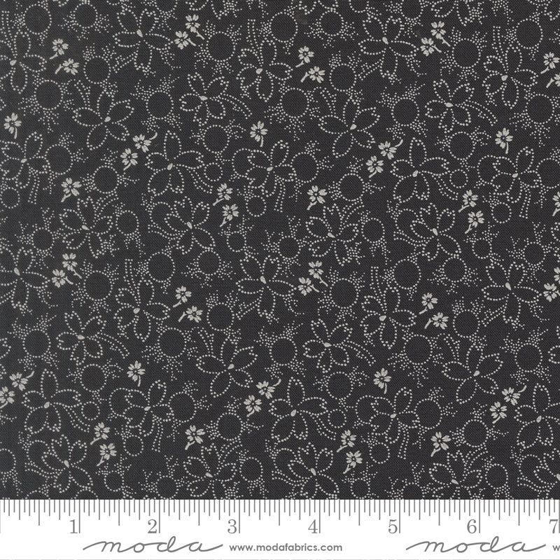 Floral pattern fabric with a ruler at the bottom for scale, on a black background.