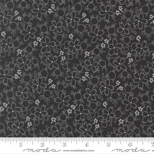 Floral pattern fabric with a ruler at the bottom for scale, on a black background.