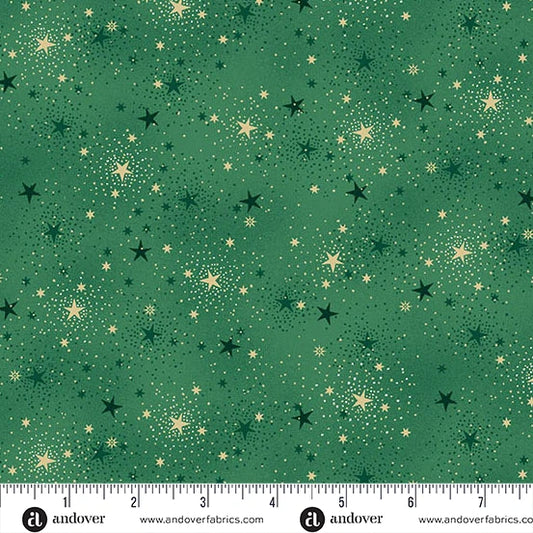 Green fabric with a scattered star pattern in black and metallic gold, shown flat with a ruler along the bottom edge for scale. Andover Fabrics branding is visible at the bottom.